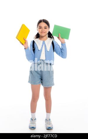 Smiling schoolgirl with books on a white background Stock Photo - Alamy