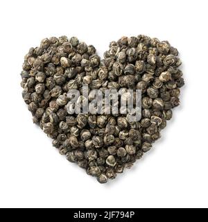 Chinese  Jasmine Dragon pearl tea in heart shape close up isolated on white background Stock Photo