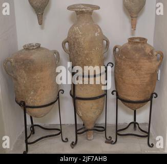 Late Roman Period. North African cylindrical amphorae (used between 3rd to 6th century AD) and two from the Maltese Islands, with low handles on shoulders and rounded bases. Found in 1961 from the site of a 5th century AD shipwreck at the mouth of Xlendi Bay (island of Gozo, Malta). Gozo Museum of Archaeology. Cittadela of Victoria in Gozo. Malta. Stock Photo