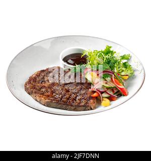 Isolated plate of grilled beef steak with salad Stock Photo