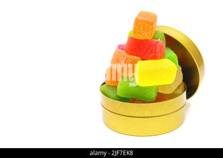 Mix of square jelly cubes stacked in a round candy box isolated on white background with copy space. Stock Photo