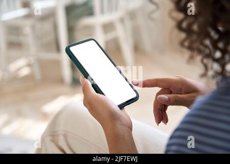Young woman user holding cell phone mock up screen touching finger. Stock Photo