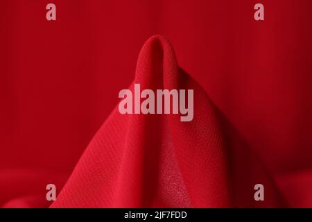 Red silk fabric closeup. Synthetic fabric bright red color Stock Photo