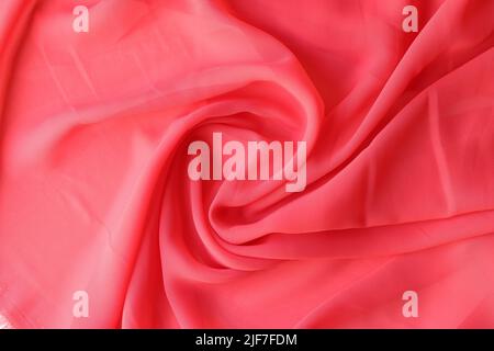 Macro texture of red fabric. Beautiful delicate pink satin fabric Stock Photo