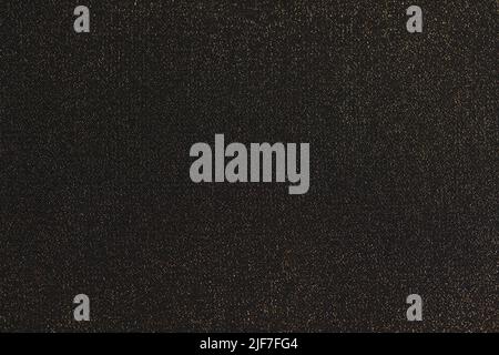 Shiny black background. Shimmering golden glitter closeup Stock Photo