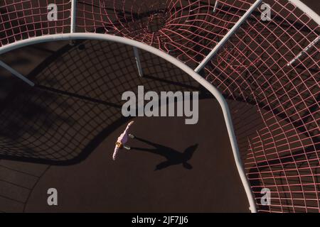 Young woman doing yoga, Aerial view Stock Photo