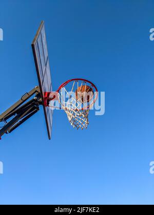 Ball in a basket on a background of clear sky Stock Photo