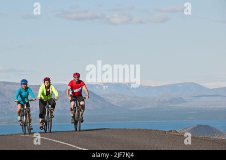 Cyclist riding around the Thingvallavatn lake in Iceland Stock Photo