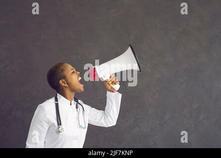 Angry ethnic female doctor make scream in speaker Stock Photo