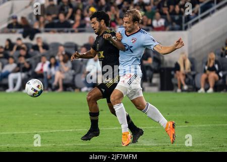 LAFC forward Carlos Vela (10) is fouled by FC Dallas midfielder Paxton Pomykal (19) during a MLS match, Wednesday, June 29, 2022, at the Banc of Calif Stock Photo