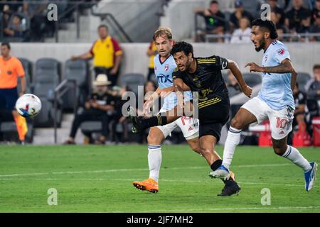 LAFC forward Carlos Vela (10) passes as FC Dallas forward Jesús Ferreira (10) and midfielder Paxton Pomykal (19) defend during a MLS match, Wednesday, Stock Photo