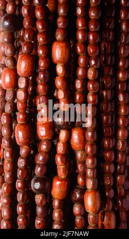 abstract background of wooden threaded curtain beads of doorway, closeup view texture can be used as wallpaper and graphic designing Stock Photo