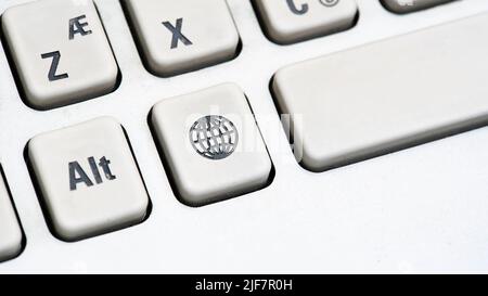 Simple internet access symbol key on a computer keyboard, earth, globe network icon button macro, detail, extreme closeup. Networking, going online, b Stock Photo