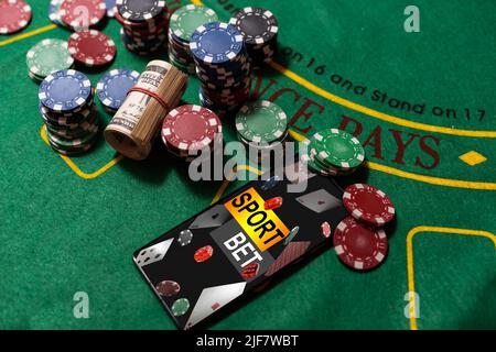 inscription your bet wins on a smartphone on the poker table. Stock Photo