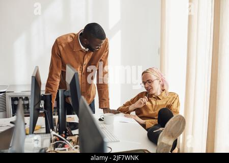 Entrepreneurs discussing over document while planning strategy during meeting in office Stock Photo