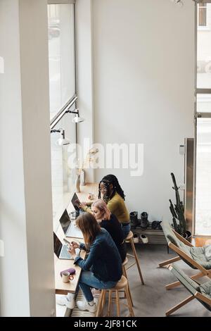 High angle view of businesswomen working together in office Stock Photo