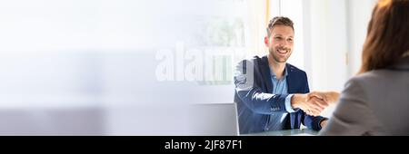 Smiling Young Businessman Shaking Hands With His Partner Stock Photo