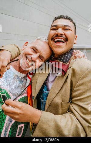 Gay man leaning his head on the shoulder of his couple on a beach Stock
