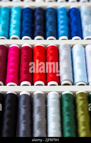 Colourful thread bobbins background Stock Photo