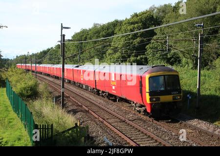 Royal mail train on West Coast Main Line railway in countryside near Scorton in Lancashire on 30th June 2022 with Anglo Scottish service. Stock Photo