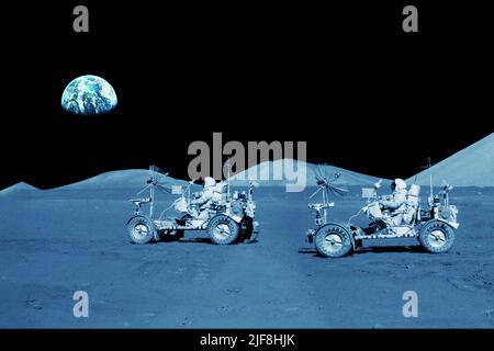 Two astronauts are riding lunar rovers on the moon. Elements of this image furnished by NASA. High quality photo Stock Photo