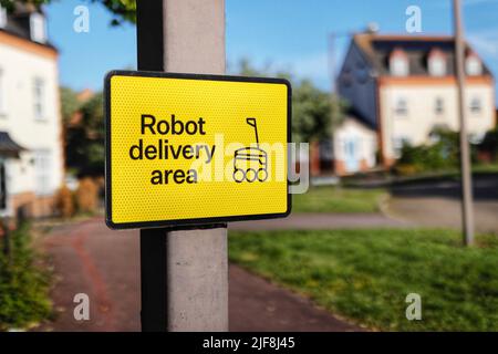 Road sign in Monkston Park, Milton Keynes alerting road users to the presence of autonomous delivery robots working in the area. Stock Photo