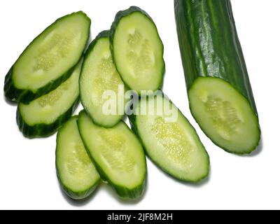 Smooth medium-sized cucumber on a white background. Cucumber slices, isolate. Sliced ​​vegetable. Vegetable isolate. Stock Photo