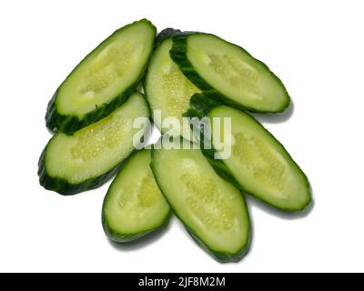 Smooth medium-sized cucumber on a white background. Cucumber slices, isolate. Sliced ​​vegetable. Vegetable isolate. Stock Photo