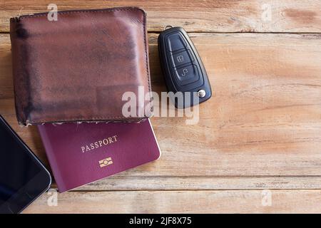 Smart phone,wallet,passport and car key on wooden table Stock Photo