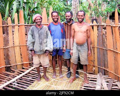 Four men building a house in the highlands of Papua, Indonesia. Stock Photo