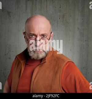 casual profile portrait of a bearded serious senior man wearing round glasses Stock Photo