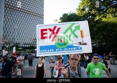 New York, United States. 30th June, 2022. ExxOff! sign held above crowd. Extinction Rebellion held a die-in in front of New York City's Supreme Court following the United States' Supreme Court vote today to limit the Environmental Protection Agency's authority to regulate greenhouse gas emissions from power plants. Credit: SOPA Images Limited/Alamy Live News Stock Photo