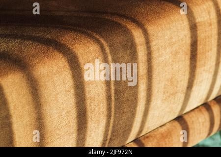 Sofa cushion with sunlight pattern on it, abstract cozy interior fragment Stock Photo