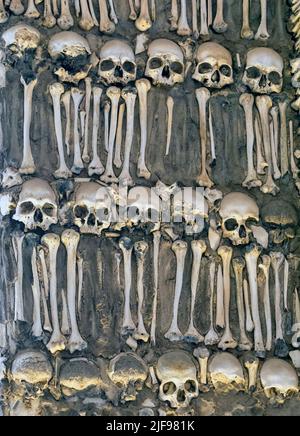 Skulls and bones cemented into the walls of the  17th century Capela dos Ossos - the Chapel of Bones, beside the entrance to  the Church of St. Franci Stock Photo