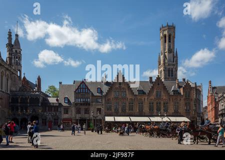 View of The Belfry Tower from Burg square in Bruges. Belgium. On the corner stands the Basilica of the Holy Blood. Stock Photo