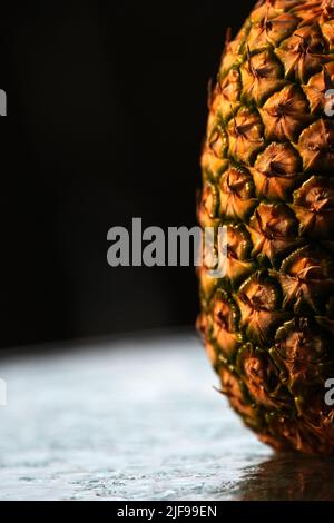 Closeup pineaple skin in a black background Stock Photo
