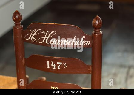 Enkhuizen, Netherlands. June 2022. Back of numbered chair in the church of Enkhuizen. High quality photo Stock Photo