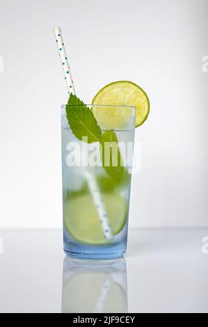 Mojito cocktail isolated on a white background in a frosted clear blue glass Stock Photo