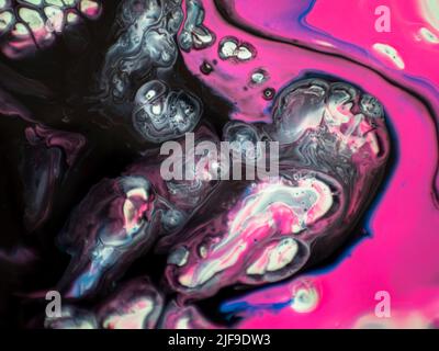 Marbled texture created with acrylic paint and watercolors mixed with water forming organic, rounded and sinuous structures perfect for backgrounds an Stock Photo
