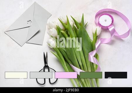 Beautiful tulip flowers, scissors, ribbon and envelopes on light background. Different color patterns Stock Photo