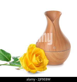 Aroma oil diffuser and rose on white background Stock Photo
