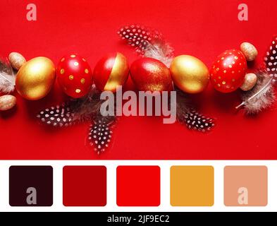 Stylish Easter eggs and feathers on red background. Different color patterns Stock Photo