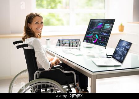 Portrait Of A Happy Businesswoman With A Graph On Computer Screen Stock Photo