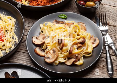 Various Italian pasta. Mushroom and tomato sauce pasta, spaghetti bolognese Stock Photo