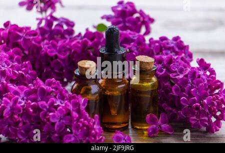 Premium Photo  Lilac essential oil in small bottles
