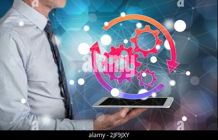 Automation concept above a tablet held by a man Stock Photo