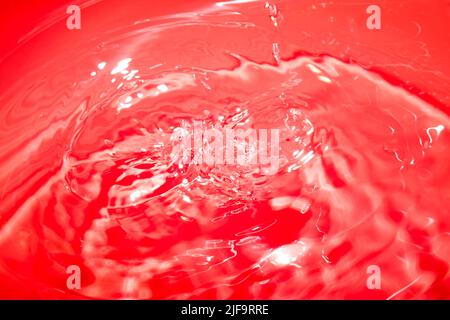 Red abstract chaotic backgroud with seamless pattern. Red liquid surface texture. Stock Photo