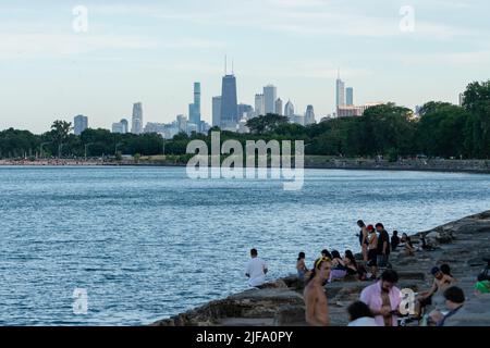 People hang out on the lakefront on a 90-degree day in Chicago, Illinois on June 30, 2022. (Photo by Max Herman/Sipa USA) Stock Photo