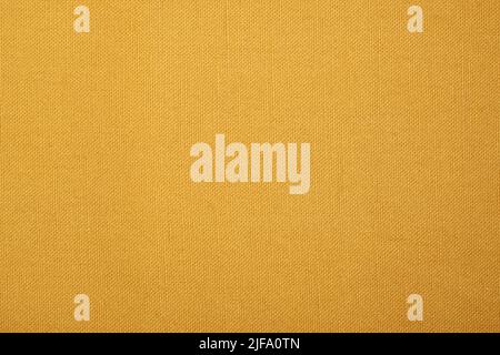 Textured fabric background. A flat linen surface in a creamy sand or camel colour. Stock Photo
