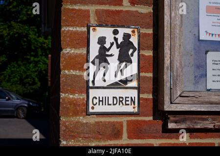 An old fashioned 'children' sign by a school in the UK. An old fashioned safety sign to alert road users that a school is here. Stock Photo